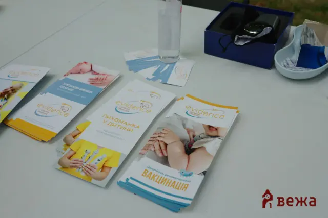 Stack of colorful brochures about evidence-based pediatrics on a white table.